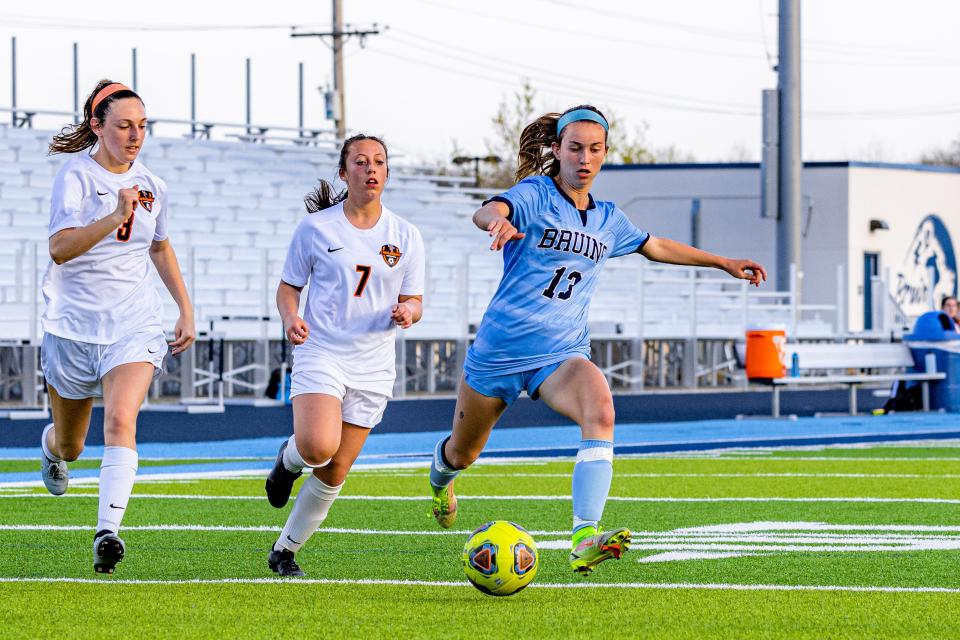 Bartlesville's Eva Sigler heads to the goal while being chased by two Tahlequah defenders during a match on April 12 at Custer Stadium.