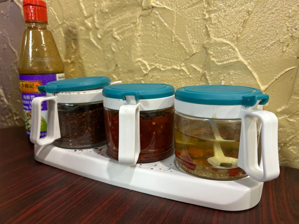 Condiments on the tables at Lyeh Thai include, from left, hoisin sauce, chili flakes, chili paste and a chili vinegar sauce.