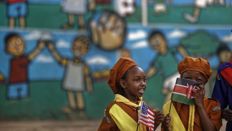 Kenyan girl guides holding U.S. and Kenyan flags await the arrival of the U.S. ambassador at a site supported by PEPFAR, the U.S. program to fight HIV/AIDS in Africa, at the St John’s Community Centre in the Pumwani area of Nairobi, Kenya Saturday, March 10, 2018.