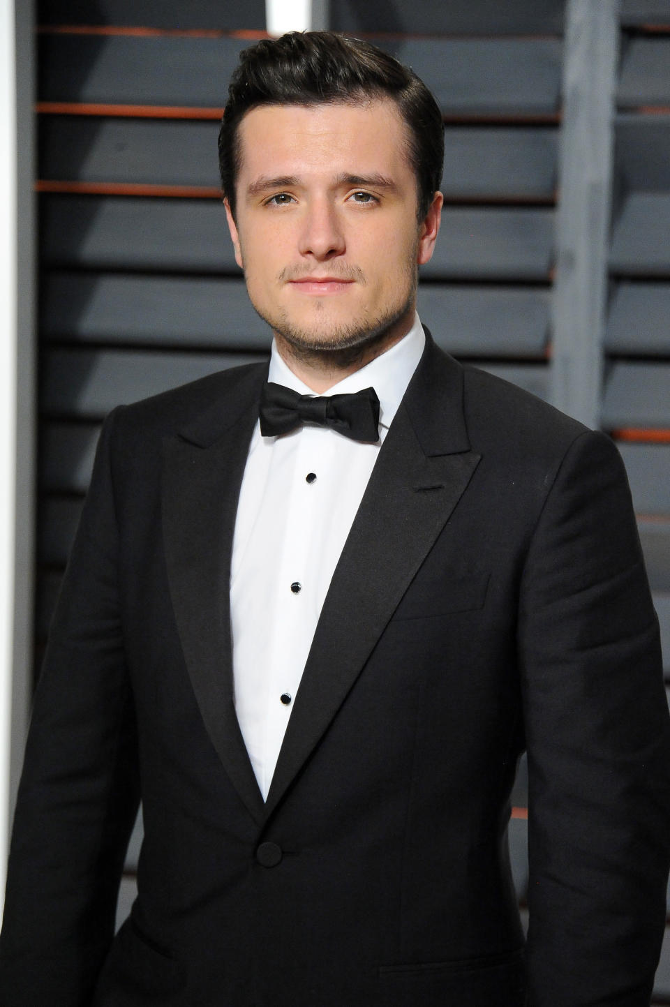 A closeup of Josh Hutcherson in a tux at a red carpet event