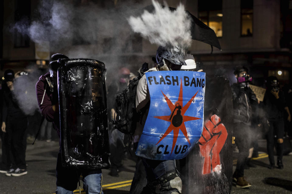 In this Aug. 19, 2020 photo, a protester is hit in the head with projectile fired by a law enforcement officer outside of the U.S. Immigration and Customs Enforcement building in Portland, Ore. Most police officers who violate citizens’ rights get away with it because the law is heavily stacked in their favor, legal experts say. (Maranie Rae Staab via AP)