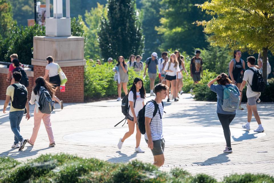 Students walk along the pedestrian walkway past the Haslam College of Business during the first day of the fall semester on the University of Tennessee's campus in Knoxville on Aug. 23.