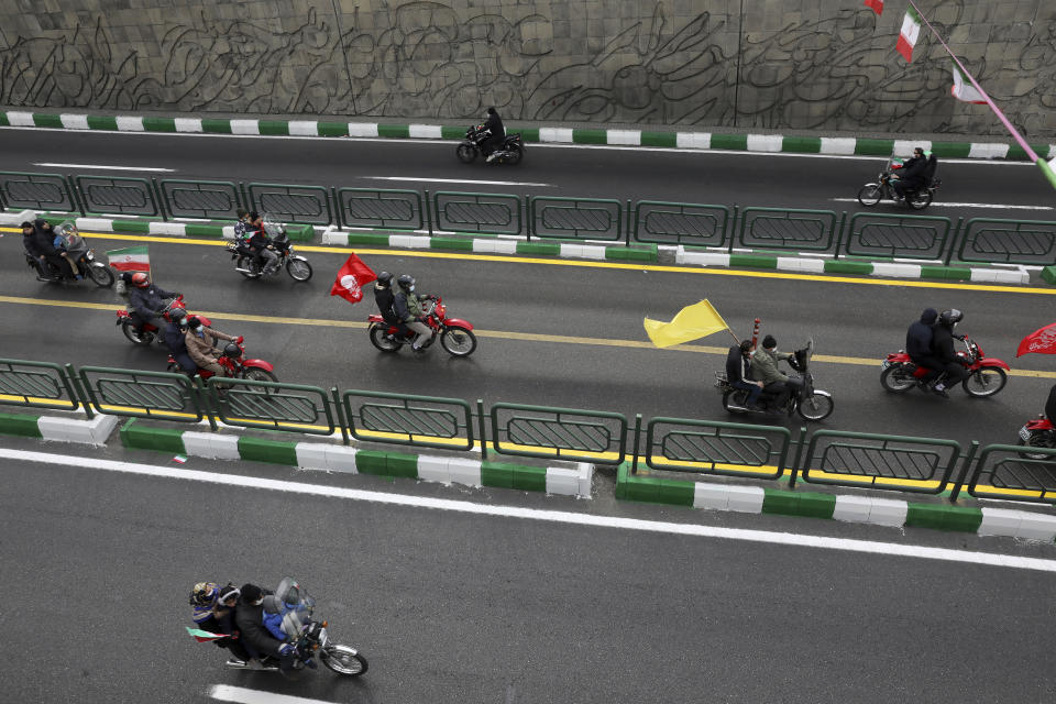 People on motorcycles attend the annual rally commemorating the anniversary of1979 Islamic Revolution in Tehran, Iran, Friday, Feb. 11, 2022. Thousands of cars and motorbikes paraded in the celebration, although fewer pedestrians were out for a second straight year due to concerns over the coronavirus pandemic. (AP Photo/Vahid Salemi)