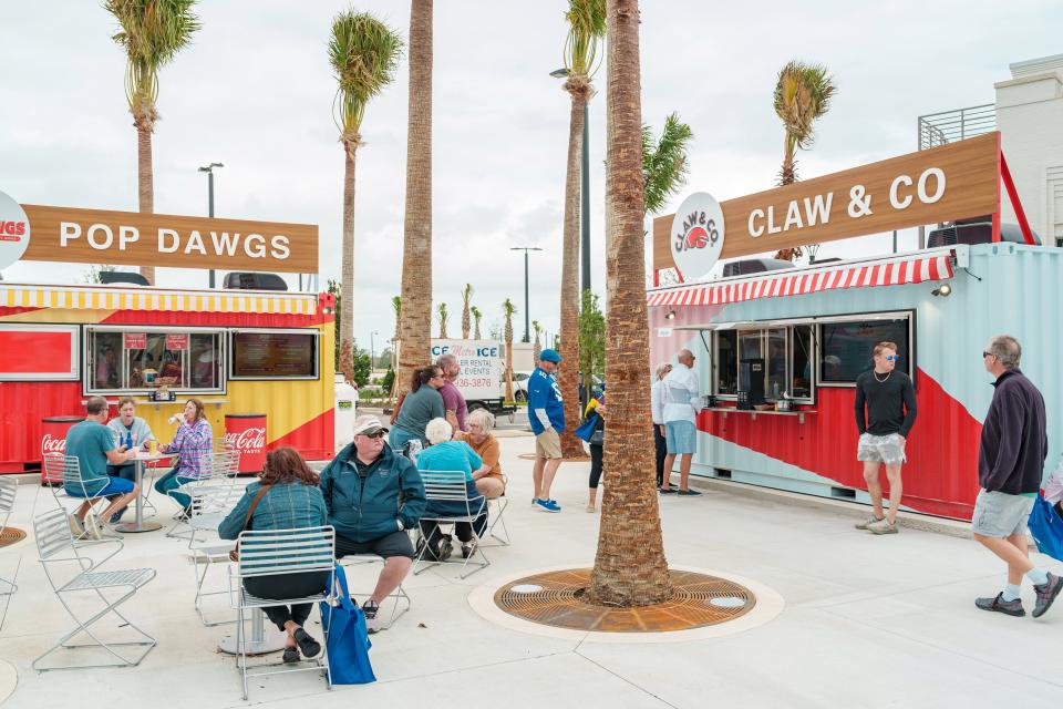 Patrons enjoy fare from Pop Dawgs and Claw & Co, two of the three vendors operating out of converted shipping containers in The Yard at Downtown Wellen Park. Currently the vendors are open during special events.