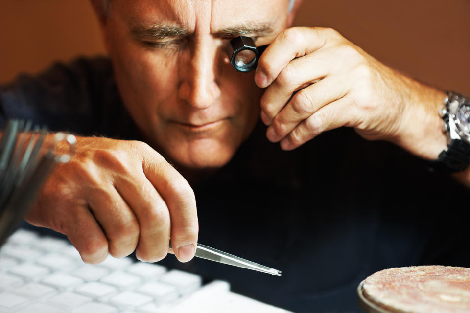 Jeweler examines a diamond through a loupe