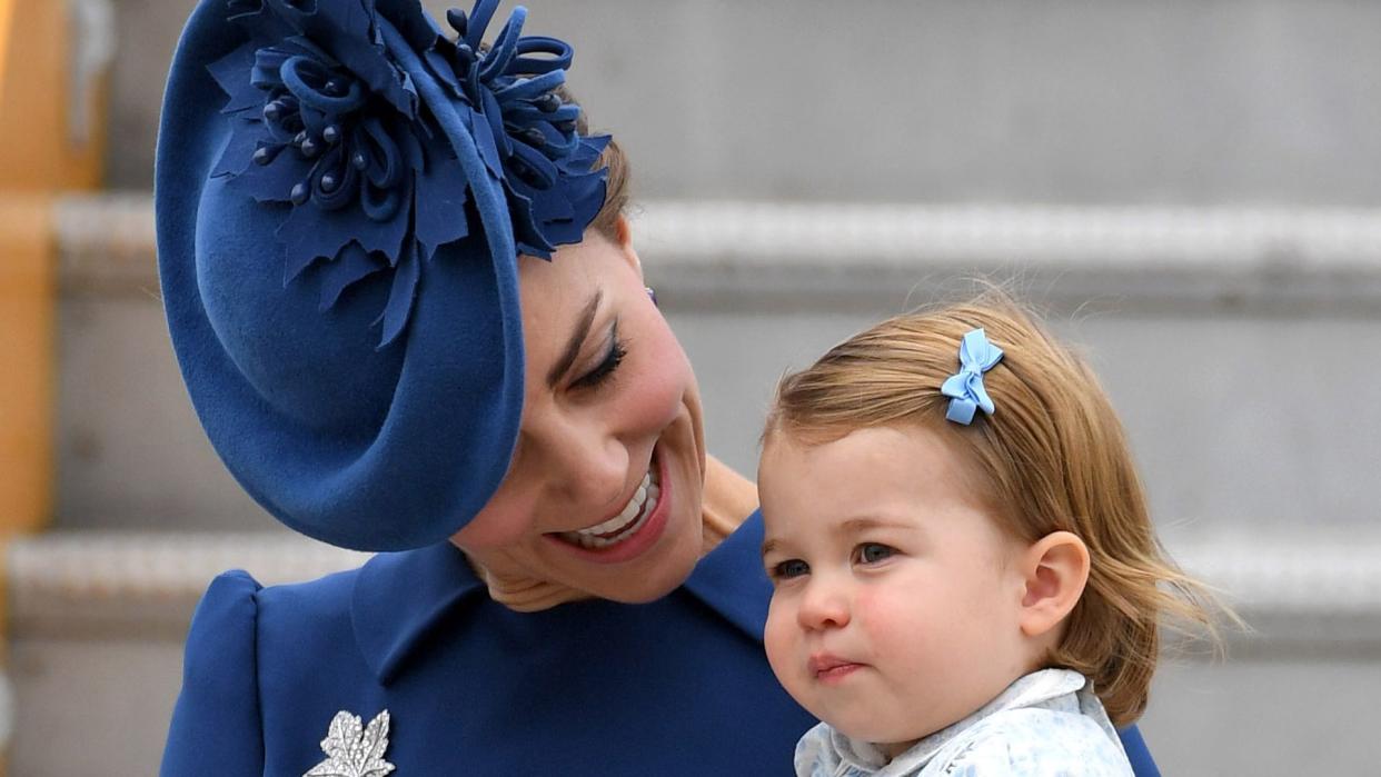 Princess Kate holding a baby Princess Charlotte