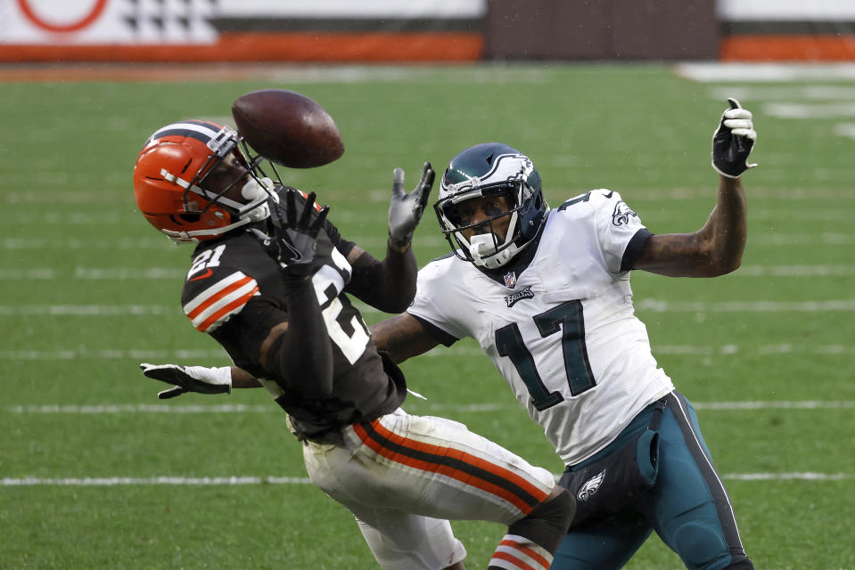 FILE - Cleveland Browns cornerback Denzel Ward (21) intercepts a pass intended for Philadelphia Eagles wide receiver Alshon Jeffery (17) during an NFL football game in Cleveland, in this Sunday, Nov. 22, 2020, file photo. The Cleveland Browns have exercised the fifth-year option on quarterback Baker Mayfield’s rookie contract. The team also did the same with top cornerback Denzel Ward’s contract. (AP Photo/Kirk Irwin, File)