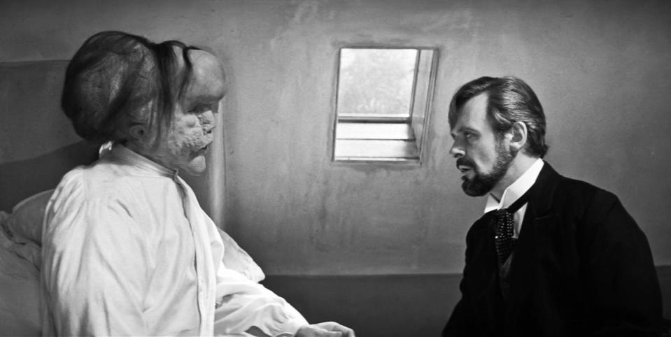 USA.  John Hurt and Anthony Hopkins in  a scene from the (C)Paramount Pictures movie: The Elephant Man (1980) .  Plot: A Victorian surgeon rescues a heavily disfigured man who is mistreated while scraping a living as a side-show freak. Behind his monstrous faade, there is revealed a person of kindness, intelligence and sophistication.  Ref: LMK110-J8757-070223 Supplied by LMKMEDIA. Editorial Only. Landmark Media is not the copyright owner of these Film or TV stills but provides a service only for recognised Media outlets. pictures@lmkmedia.com