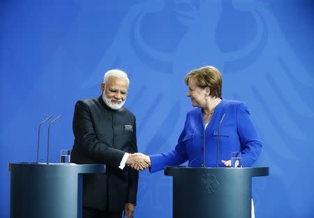 German Chancellor Angela Merkel shakes hands with Indian Prime Minister Narendra Modi following a news conference at the Chancellery in Berlin, Germany, May 30, 2017. REUTERS/Hannibal Hanschke