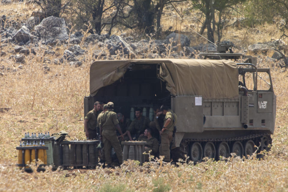 Israeli soldiers gather near shells at an Israeli mobile artillery unit in northern Israel near the border with Lebanon, Tuesday, July 28, 2020. The Israeli military on Monday said it thwarted an infiltration attempt by Hezbollah militants — setting off one of the heaviest exchanges of fire along the volatile Israel-Lebanon frontier since a 2006 war between the bitter enemies. (AP Photo/Ariel Schalit)