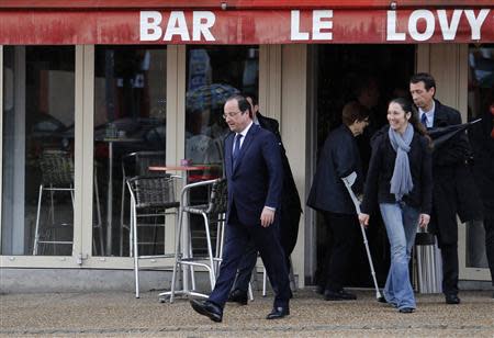 France's President Francois Hollande leaves a bar after voting in the first round in the French mayoral elections in Tulle, center France, March 23, 2014. REUTERS/Regis Duvignau