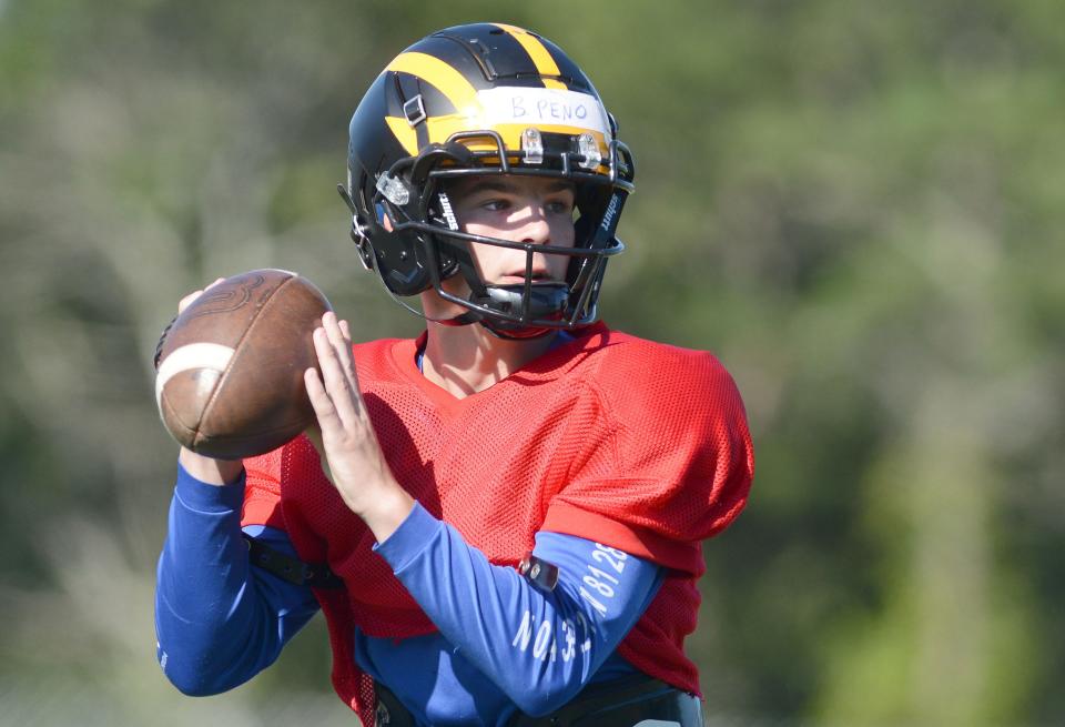 Sophomore Brendan Peno looks down field while running offense drills recently as Nauset High School's football team took to the gridiron for an early morning practice.