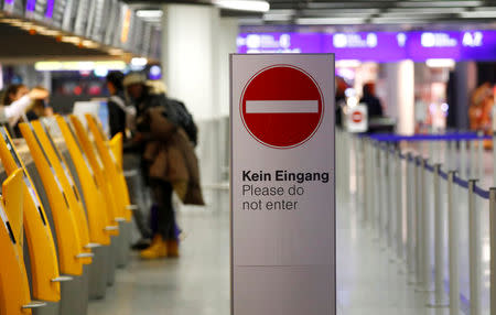 A sign is seen as stranded passengers get information at a check-in desk of German airline Lufthansa during a strike of security personnel over higher wages at Germany's largest airport in Frankfurt, Germany, January 15, 2019. REUTERS/Kai Pfaffenbach