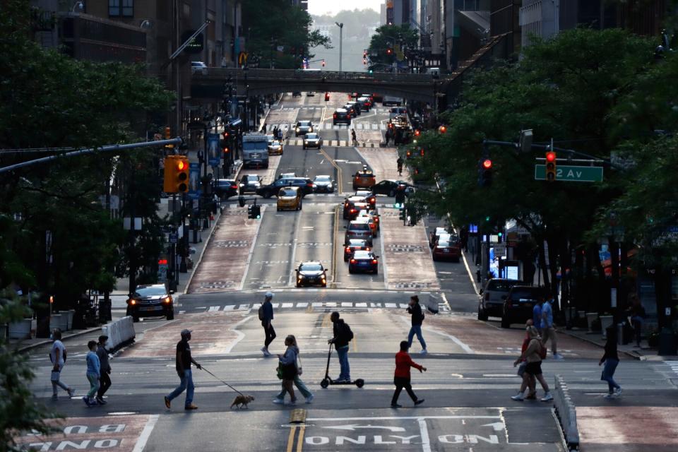 People cross 42nd Street as the sun sets on June 1, 2021 in New York City.