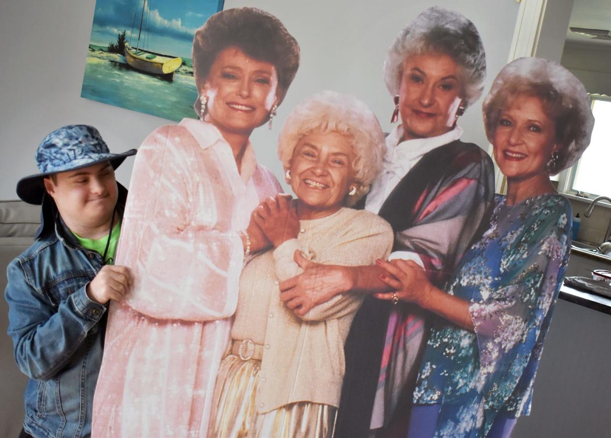Somerset resident Alex Rogers, known around town as "Superhero Alex," is seen at his home with cutouts of his favorite "Golden Girls" characters.