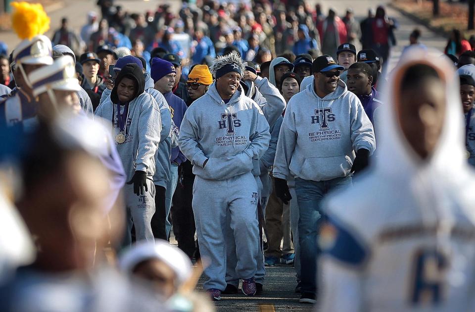 Trezevant High School Coach Teli White leads his team down Central Avenue during the Parade of Champions put on by the City of Memphis to honor players from East, Lausanne, Trezevant and Whitehaven high schools who all won their respective football championships.