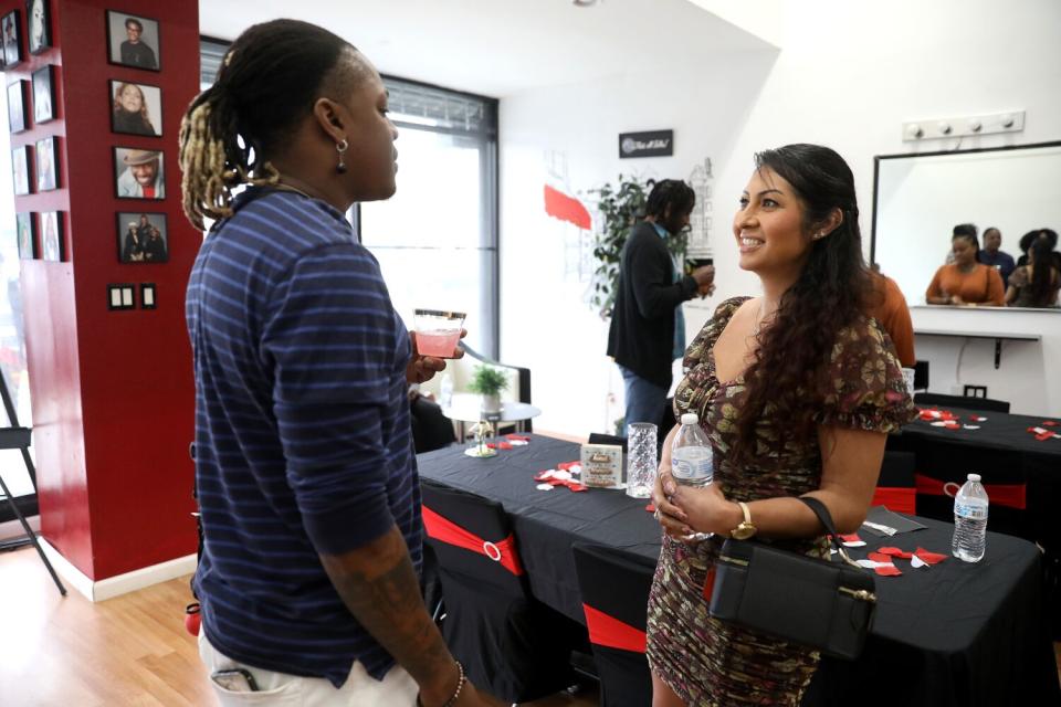 Two daters talk with their blindfolds off at the end of the speed dating event.