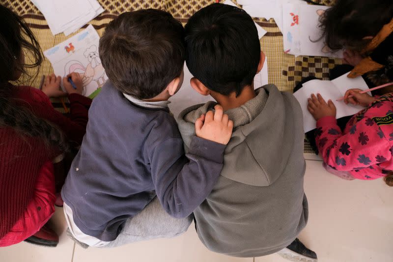 Children draw at a makeshift shelter in Mersin