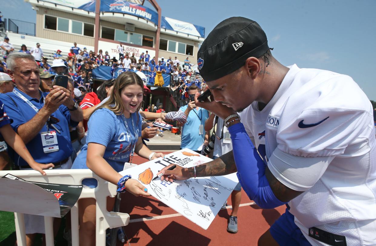 Bills wide receiver Keon Coleman stops to vote for flats as Stephanie Mirras, Seneca Falls, with her father Michael Mirras, and brother James Mirras ask players to vote for their favorite type of chicken wings during the opening day of Buffalo Bills training camp at St. John Fisher Universtiy Wednesday, July 24, 2024. The winner, by a landslide, was flats.