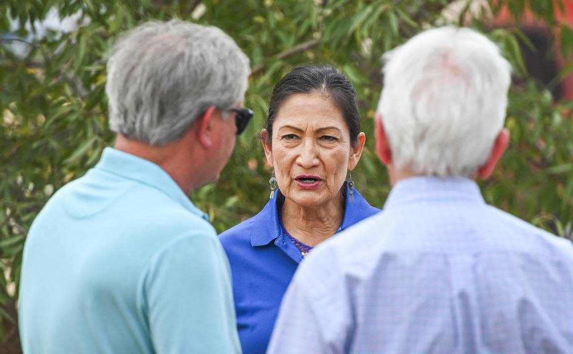 U.S. Secretary of the Interior Deb Haaland, center, talks with farmer Kevin Herman, left, and Congressman Jim Costa while touring a Madera County, Calif. farm with federal, state and local leaders and working on water solutions for farmers as well as highlighting investments from the Bipartisan Infrastructure Law and Inflation Reduction Act, on Wednesday, Aug. 17, 2022.