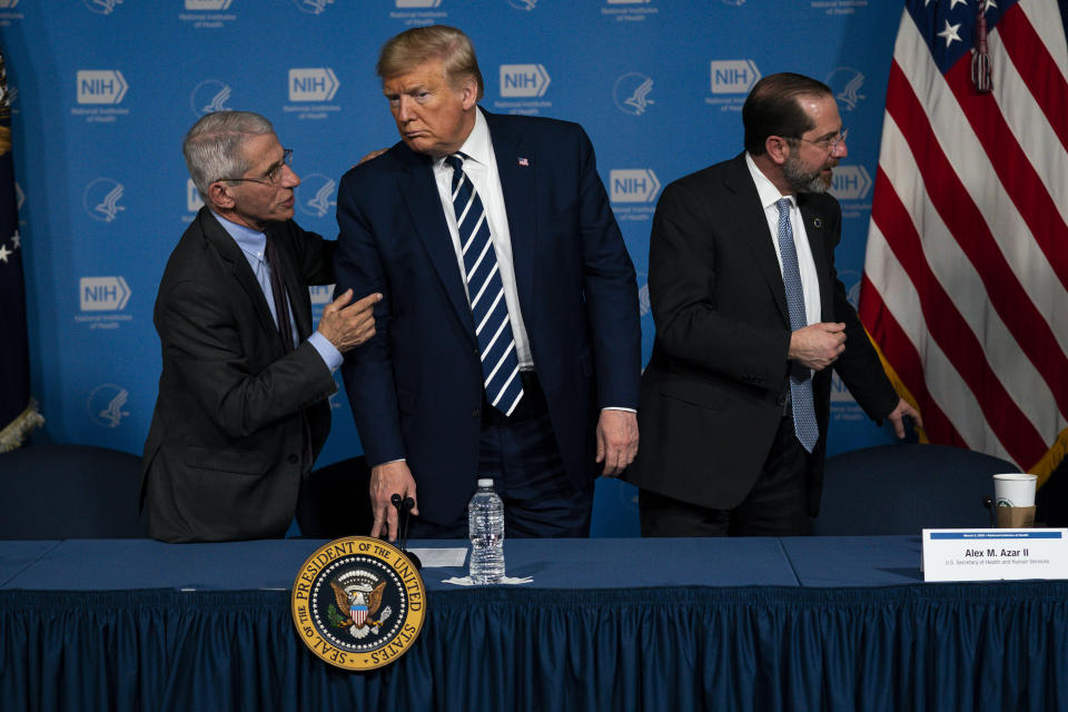 Dr. Anthony Fauci, director of the National Institute of Allergy and Infectious Diseases, left, President Donald Trump, center, and Secretary of Health and Human Services Alex Azar leave a briefing on the coronavirus at the National Institutes of Health, Tuesday, March 3, 2020, in Bethesda, Md. (AP Photo/Evan Vucci)