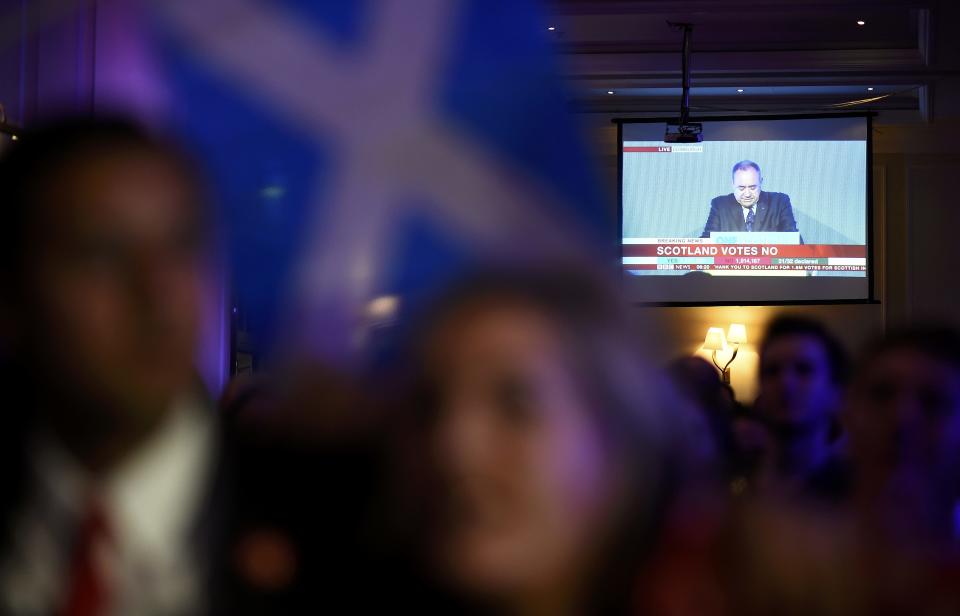 Scotland's First Minister Alex Salmond speaks to television as supporters from the "No" Campaign celebrate in Glasgow, Scotland