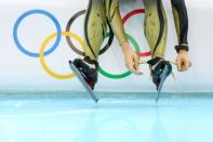 A member of the Japan speed skating team prepares to practise on the ice during a training session ahead of the Sochi 2014 Winter Olympics at Adler Arena Skating Center