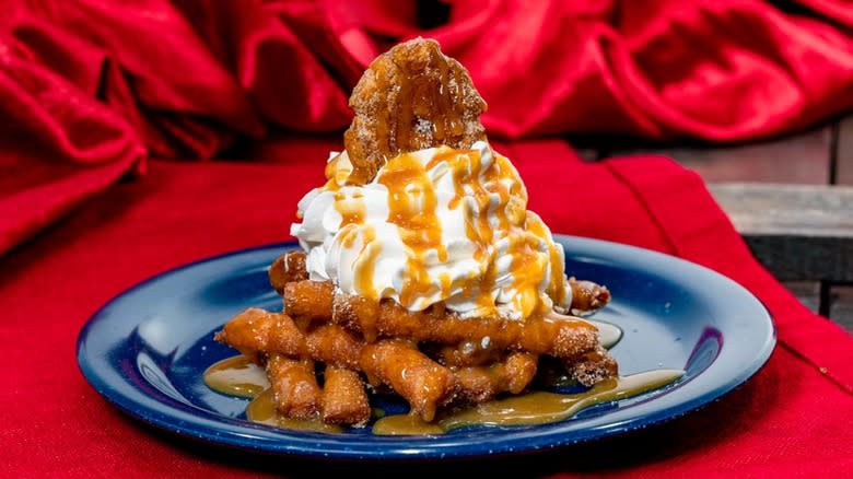Funnel cake fries on a blue plate