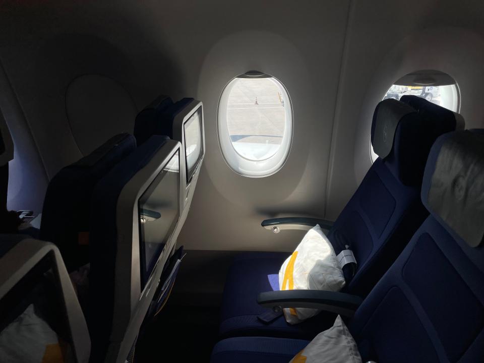 An economy seat on a long-haul Lufthansa flight.