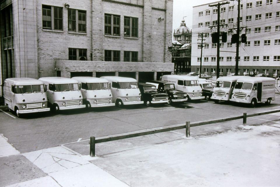 The Green Bay Press-Gazette's fleet of delivery vehicles parked in the 435 E. Walnut St. building lot with the Brown County Courthouse and Green Bay City Hall to the right in 1965.