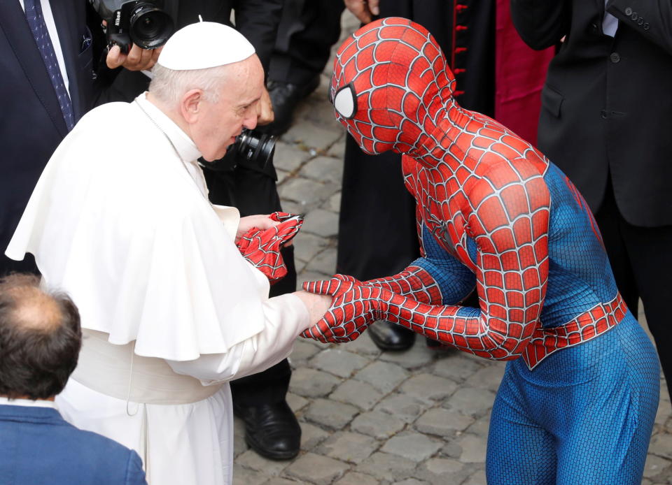 Pope Francis receives a Spider-Man mask from a person dressed as Spider-Man after the general audience, amid the coronavirus disease (COVID-19) pandemic, at the Vatican, June 23, 2021. REUTERS/Remo Casilli
