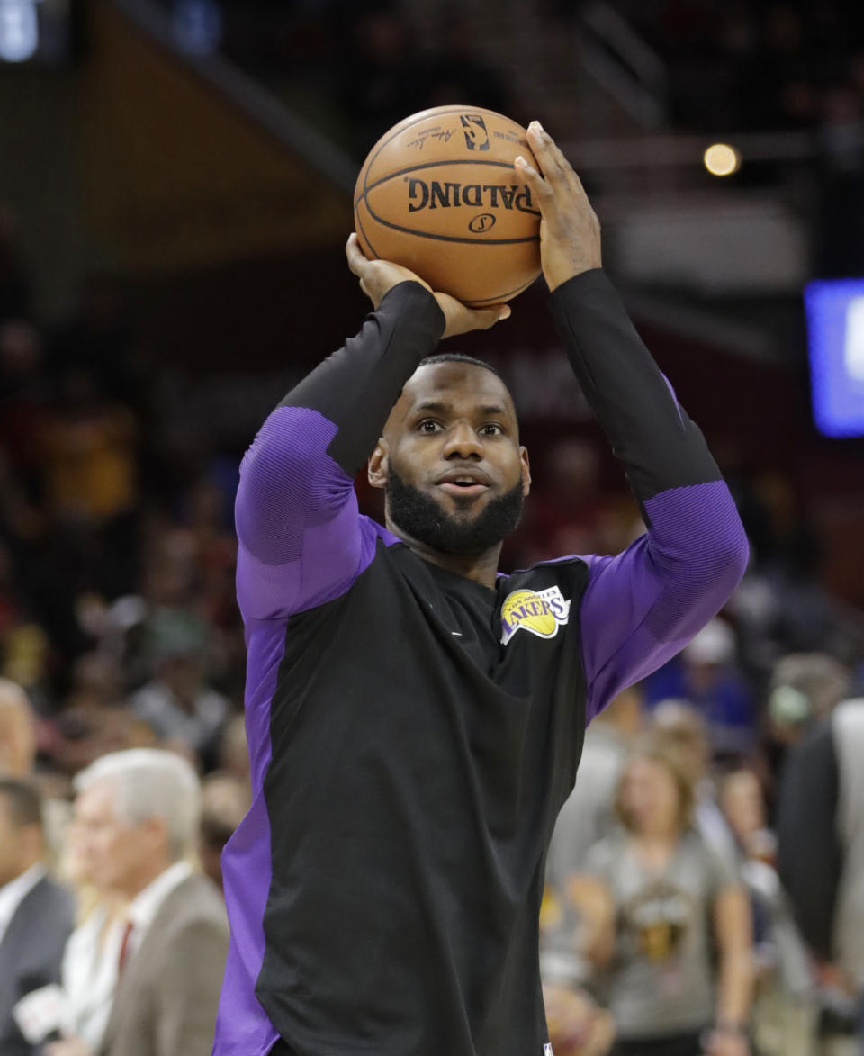 Los Angeles Lakers' LeBron James warms up before the team's NBA basketball game against the Cleveland Cavaliers, Wednesday, Nov. 21, 2018, in Cleveland. (AP Photo/Tony Dejak)