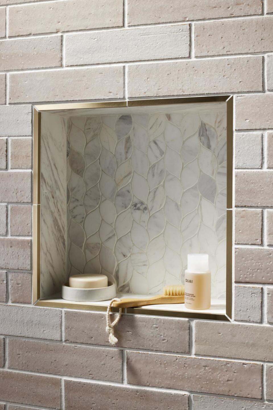 Elia Greek marble tile edged by metallic gold trim