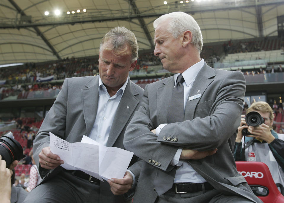 FILE - Stuttgart coach Giovanni Trapattoni sits beside assistant Andreas Brehme, left, during the UEFA Cup first round, first leg match between VfB Stuttgart and Slovenian NK Domzale at the Gottlieb Daimler stadium in Stuttgart, on Sept. 15, 2005. Andreas Brehme, who scored the only goal as West Germany beat Argentina to win the 1990 World Cup final, has died. He was 63. Brehme’s partner Susanne Schaefer has confirmed his death in a statement to Germany’s dpa news agency. (AP Photo/Daniel Maurer, File)