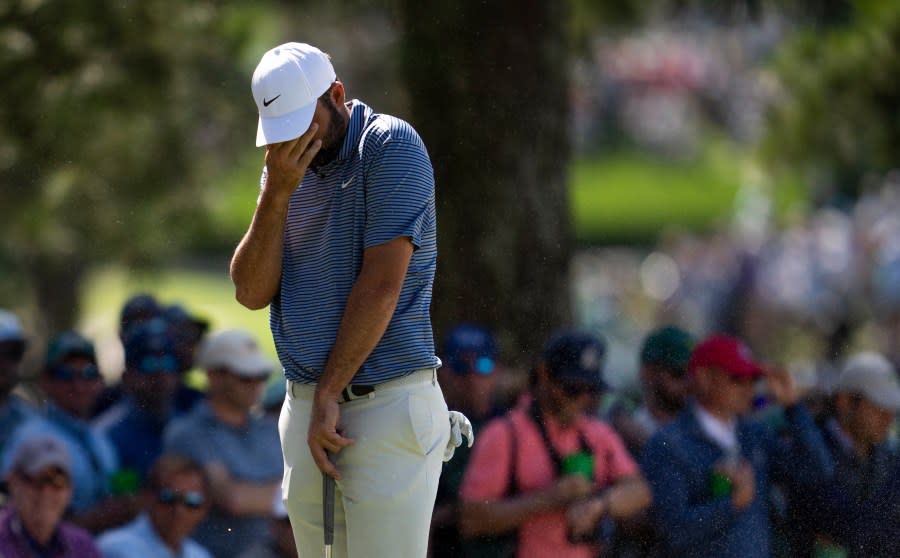 Masters champion Scottie Scheffler of the United States protects his eyes from the sand in the wind during the second round of the 2024 Masters Tournament at Augusta National Golf Club, Friday, April 12, 2024. (Photo courtesy: Augusta National Golf Club)