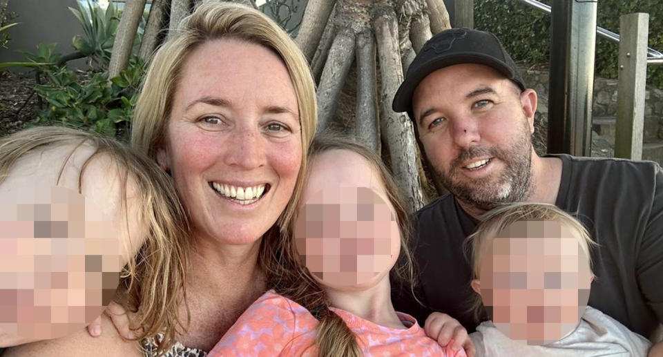 Jase and Emma pictured in a smiling selfie with their three young children.