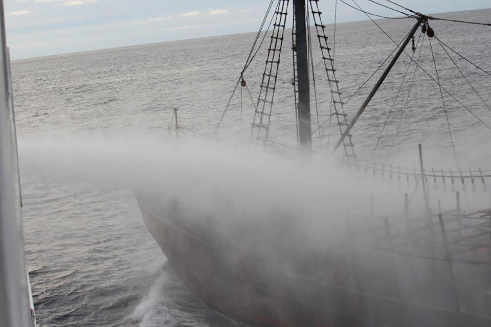 In this Monday, Oct. 7, 2019, photo released by Japan's Fisheries Agency, a fishing boat, right is sprayed water from a Japanese patrol vessel before they collide off the northwestern coast of the Noto Peninsula, Ishikawa prefecture, Japan. Japanese authorities said they rescued all of about 60 North Korean fishermen whose boat collided with a Japanese patrol vessel and sank Monday in an area crowded with poachers. (Fisheries Agency via AP)