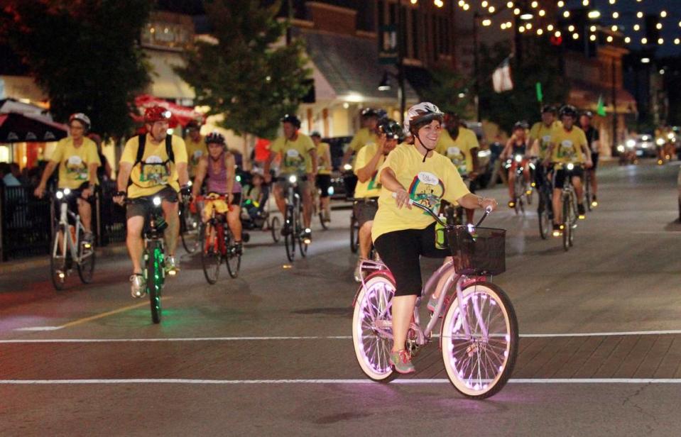 A large group of friends and family ride on East Main Street.