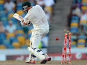 Australian batsman Michael Hussey is clean bowled off West Indies bowler Kemar Roach during the final day of the first-of-three Test matches between Australia and West Indies at the Kensington Oval stadium in Bridgetown on April 11, 2012. Australia is chasing a target of 192 runs to win the match. AFP PHOTO/Jewel Samad (Photo credit should read JEWEL SAMAD/AFP/Getty Images)