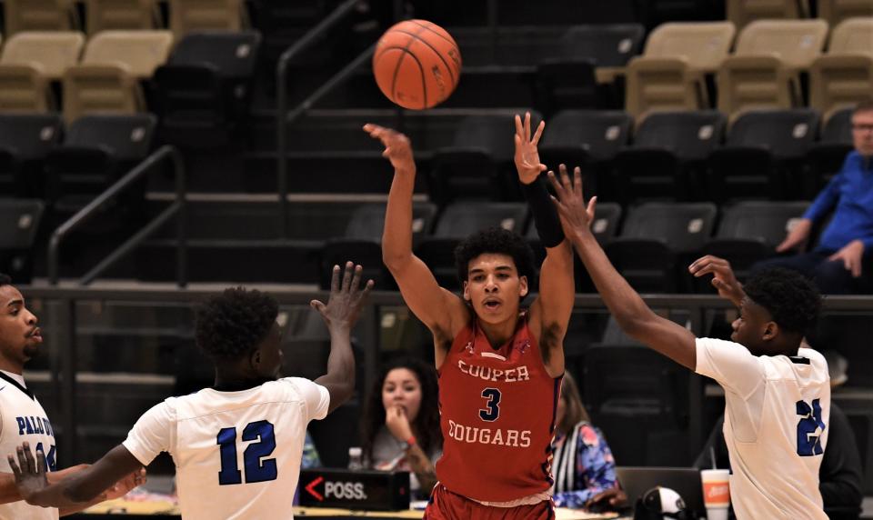 Cooper's Jordan Willis (3) passes the ball while Amarillo Palo Duro's Walid Abdelrahim (12) and Eli Igiranez (24) defend. The Dons beat Cooper 50-42 in the Region I-5A bi-district playoff game Tuesday, Sept. 21, 2023, in Lamesa.