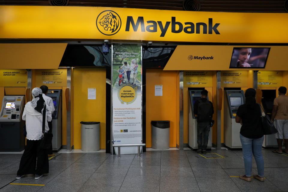 People following social distancing measures wait in line to use ATM machines at a Maybank branch in Kuala Lumpur, amid the coronavirus disease (COVID-19) outbreak in Kuala Lumpur, Malaysia September 9, 2020. REUTERS/Lim Huey Teng