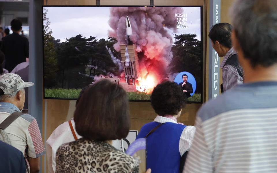 People watch a TV showing a file image of a North Korea's missile launch during a news program at the Seoul Railway Station in Seoul, South Korea, Tuesday, Sept. 10, 2019. North Korea launched at least two unidentified projectiles toward the sea on Tuesday, South Korea's military said, hours after the North offered to resume nuclear diplomacy with the United States but warned its dealings with Washington may end without new U.S. proposals.(AP Photo/Ahn Young-joon)