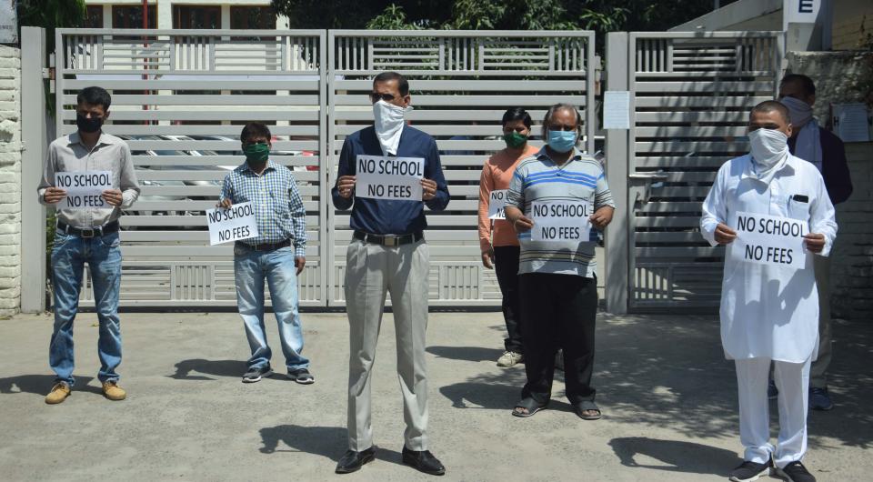 CHANDIGARH, INDIA - MAY 27: Parents protesting outside Shishu Niketan Model Sr. Sec. School in Sector 22 against the schools demand for fees during lockdown period, on May 27, 2020 in Chandigarh, India. The parents say no online classes have been held during lockdown. (Photo by Keshav Singh/Hindustan Times via Getty Images)