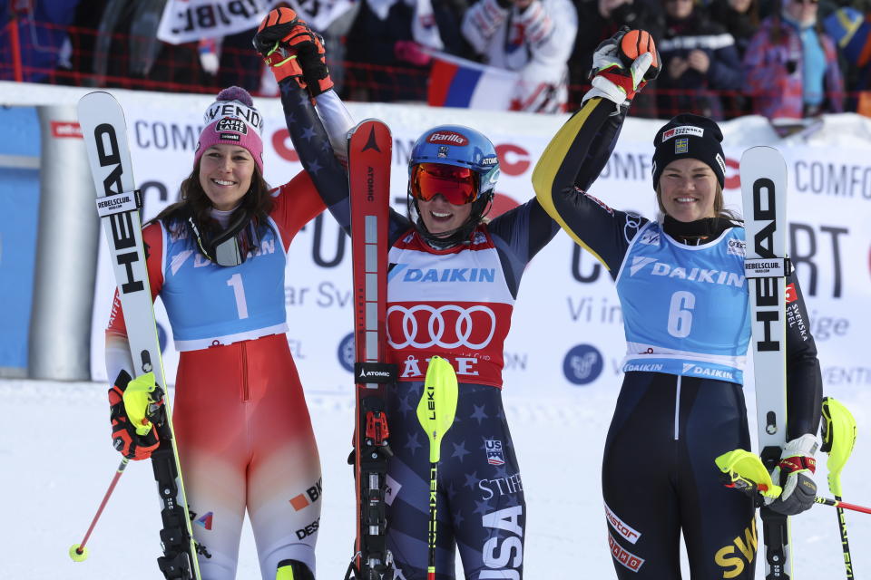 From left, second placed Switzerland's Wendy Holdener, the winner United States' Mikaela Shiffrin and third placed Sweden's Anna Swenn Larsson celebrate after an alpine ski, women's World Cup slalom, in Are, Sweden, Saturday, March 11, 2023. (AP Photo/Alessandro Trovati)