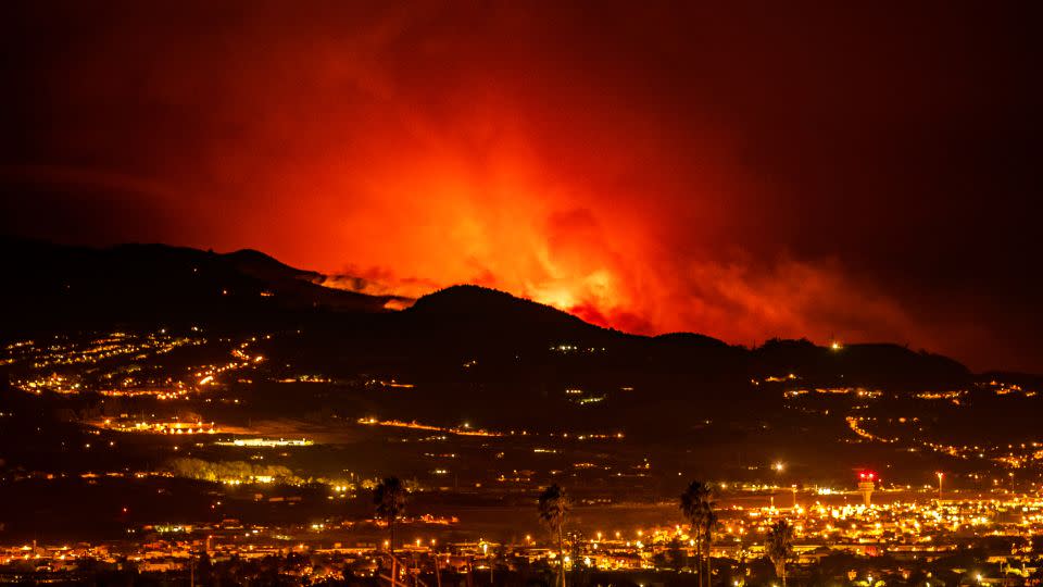 Flares are seen on the horizon as the fire advances through the forest toward the town of La Laguna and Los Rodeos airport. - Arturo Rodriguez/AP