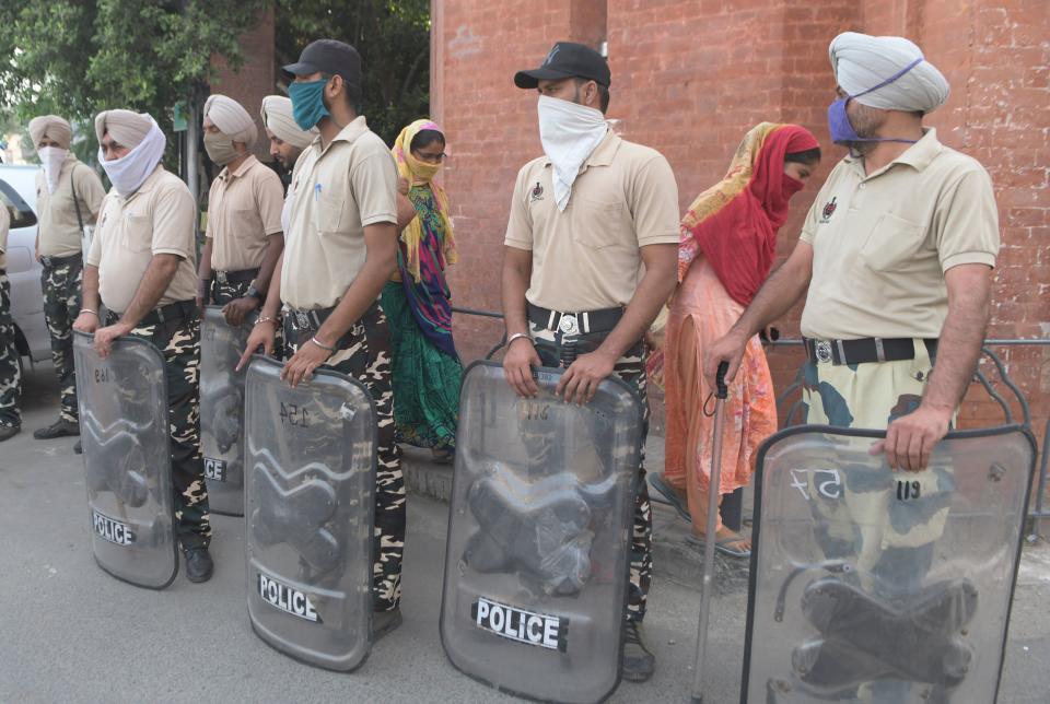 Punjab Police personnel stand guard during Bharat Bandh, a nationwide farmers' strike, following the recent passing of agriculture bills in the Lok Sabha (lower house), in Amritsar on September 25, 2020. (Photo by NARINDER NANU/AFP via Getty Images)