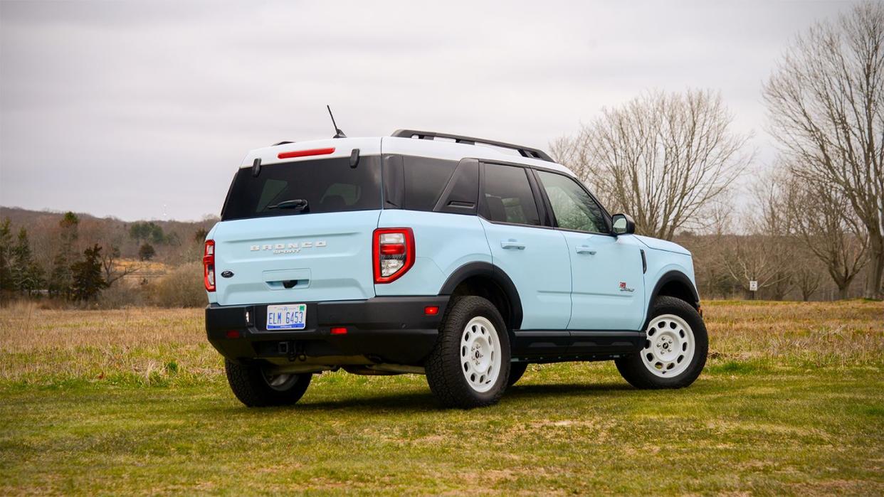 light blue 2023 ford bronco sport heritage limited 4x4 parked on the grass with the back to the camera