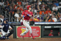 Philadelphia Phillies' Nick Maton watches his single off his brother, Houston Astros relief pitcher Phil Maton, as catcher Christian Vazquez watches during the eighth inning of a baseball game Wednesday, Oct. 5, 2022, in Houston. (AP Photo/David J. Phillip)