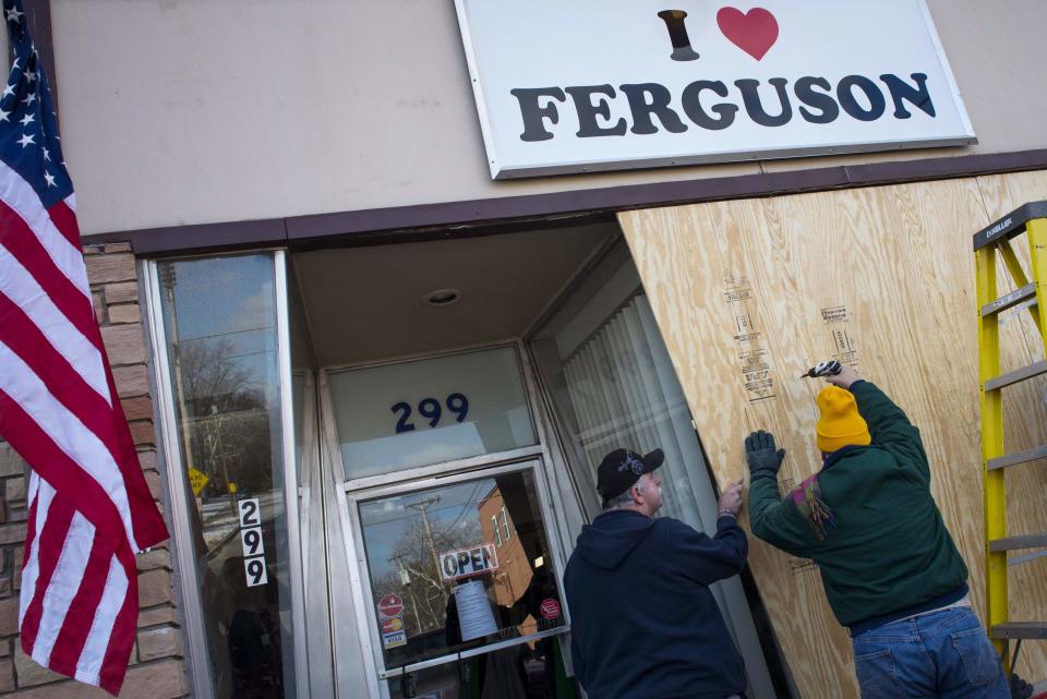 Volunteers board up the "I Love Ferguson" headquarters in preparation for the grand jury verdict in the shooting death of Michael Brown in Ferguson, Missouri, November 18, 2014. The grand jury is expected to reach a decision this month on whether to indict Darren Wilson, the white police officer who shot and killed the 18-year-old Brown, who was black, on Aug. 9 in the St. Louis suburb of Ferguson. REUTERS/Kate Munsch (UNITED STATES - Tags: CRIME LAW CIVIL UNREST POLITICS)