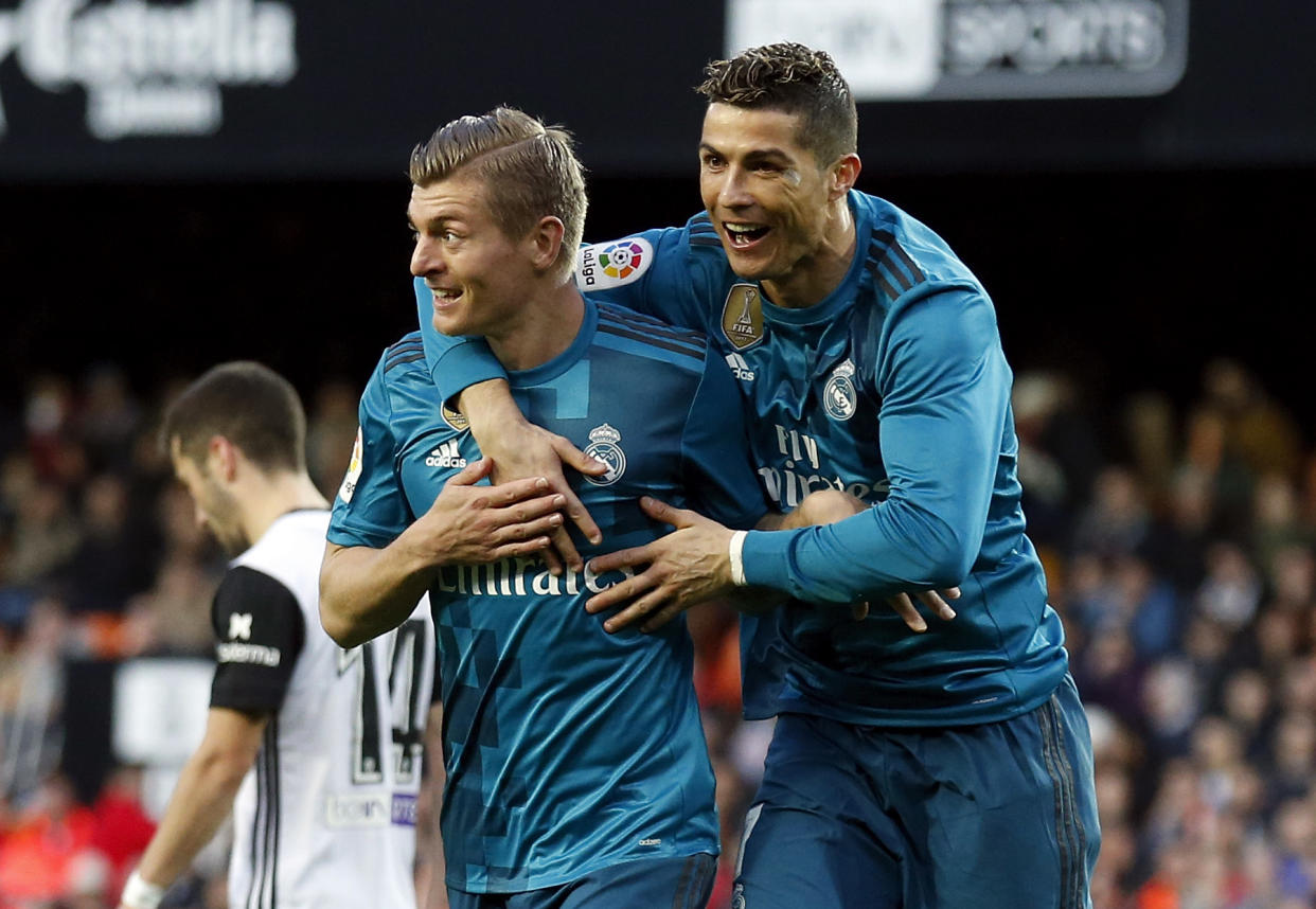 Toni Kroos and Cristiano Ronaldo celebrate one of Real Madrid’s four goals at Valencia on Saturday. (Getty)